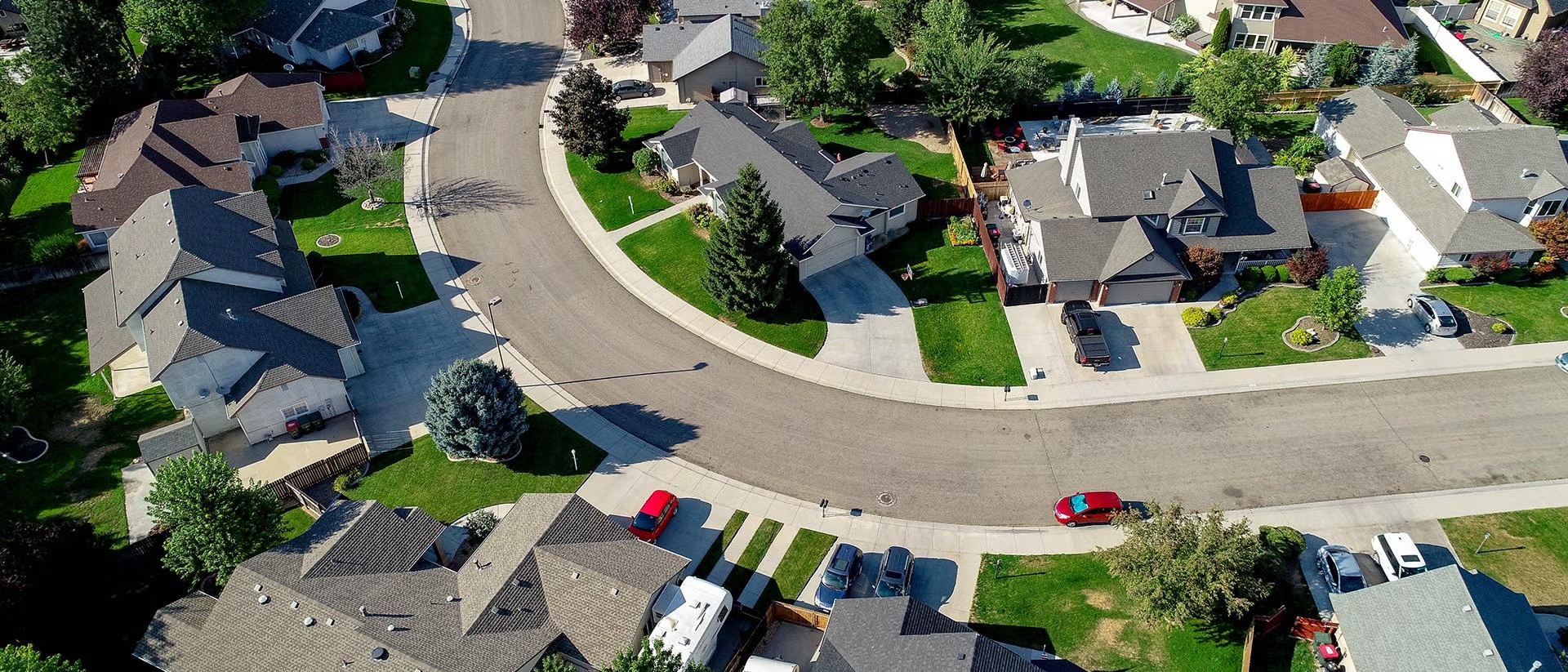 Photo of an American suburban neighborhood with a long, winding road.