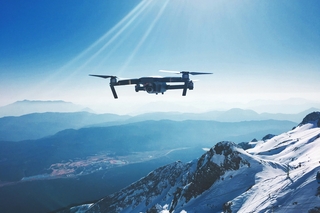 Drone over mountaintop Iewek Gnos on Unsplash